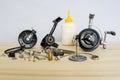 A fishing spinning reel as a whole and a second similar completely disassembled. Concept: parts of a whole. Royalty Free Stock Photo