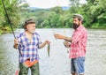 Fishing with spinning reel. Fishing peaceful activity. Fisherman family at river. Rod tackle. Fishing equipment. Great Royalty Free Stock Photo