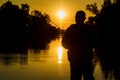 Fishing. spinning at sunset. Silhouette of a fisherman.