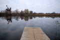 Empty wooden deck floor over the lake. Royalty Free Stock Photo