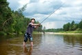 Fishing before the storm. A young man catches a fish on spinning Royalty Free Stock Photo