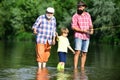 Fishing. Summer weekend. Father and son fishing. Fishing in river. Three generations ages: grandfather, father and young Royalty Free Stock Photo