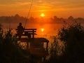 Fishing by the sunrise in the lake. Royalty Free Stock Photo