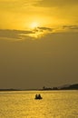 Fishing at sunset under beams and reflections of yellow light, Sithonia Royalty Free Stock Photo