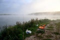 Fishing supplies on river in morning in fog Royalty Free Stock Photo