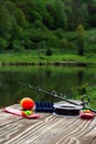 Fishing supplies on a table near a lake Royalty Free Stock Photo