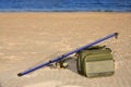 Fishing surfcasting rod and box over beach sand