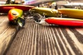 Fishing tackle background. Fishing tackles and wobbler on wooden board. Fishing hooks, lures and baits. Fishing gear on a dark tab Royalty Free Stock Photo