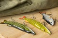 Fishing tackle and fishing lures on the background of the wooden planks.