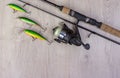 Fishing tackle - fishing spinning, hooks and lures on light wooden background. Royalty Free Stock Photo