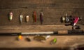 Fishing tackle - fishing spinning, hooks and lures on light wooden background.Top view. Royalty Free Stock Photo