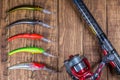 Fishing tackle - fishing spinning, hooks and lures on wooden background.Top view. Royalty Free Stock Photo