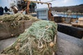 Fishing tackle and nets for trawling fishing are in the port docklie on the background of the ship