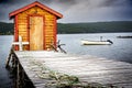 Fishing tackle shack overlooking a small bay with fishing boats on the Atlantic Ocean under a stormy sky near Royalty Free Stock Photo