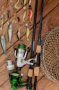Fishing tackle - fishing spinning, hooks and lures on wooden background with copy space Royalty Free Stock Photo