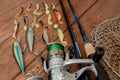 Fishing tackle - fishing spinning, hooks and lures on wooden background with copy space Royalty Free Stock Photo