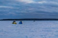 Fishing tents on the frozen and snow-covered lake