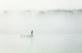 Fishing in a thick morning fog Royalty Free Stock Photo