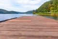 Fishing tourism relax concept. Beautiful forest lake or river on sunny summer day and old rustic wooden dock or pier. Fishing Royalty Free Stock Photo