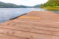 Fishing tourism relax concept. Beautiful forest lake or river on sunny summer day and old rustic wooden dock or pier. Fishing Royalty Free Stock Photo