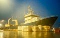 Fishing trawler ship at dock by night in drizzling rain