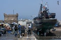 A fishing trawler sits in dry dock at the busy fishing port of Essaouira in Morocco.