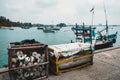 Fishing trawler and various equipment at a pier. Trawling as a traditional local craftsmanship in Sri Lanka. Fishing accessories: