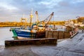 Fishing trawlers moored at Kirkcudbright harbour on the River Dee at sunset