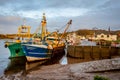 Fishing trawlers moored at Kirkcudbright harbour on the River Dee at sunset Royalty Free Stock Photo