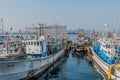 Fishing trawlers moored to concrete dock at seaport