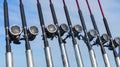 Fishing trolling boat rods in rod holder. Big game fishing. Fishing reels and rods pattern on boat. Sea fishing rods and reels in Royalty Free Stock Photo