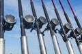Fishing trolling boat rods in rod holder. Big game fishing. Fishing reels and rods pattern on boat. Sea fishing rods and reels in Royalty Free Stock Photo