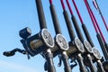 Fishing trolling boat rods in rod holder. Big game fishing. Fishing reels and rods pattern on boat. Sea fishing rods and reels in Royalty Free Stock Photo