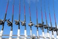 Fishing trolling boat rods in rod holder. Big game fishing. Fishing reels and rods pattern on boat. Sea fishing rods and reels in Royalty Free Stock Photo