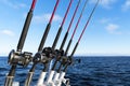 Fishing trolling boat rods in rod holder. Big game fishing. Fishing reels and rods pattern on boat. Sea fishing rods and reels in Royalty Free Stock Photo