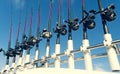 Fishing trolling boat rods in rod holder. Big game fishing. Fishing reels and rods pattern on boat. Sea fishing rods and reels in Royalty Free Stock Photo