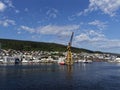 Fishing Vessels moored beside a large Yellow Shore Crane at the Fishing Port in Bergen Royalty Free Stock Photo