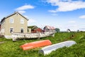 Fishing village living wooden houses and boats in front with blue sky in the background, Flatey island, Iceland Royalty Free Stock Photo