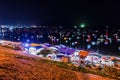 Fishing village of Mui Ne local fresh sea food market on the beach at night with many fishing boats on the sea