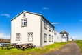 Fishing village street with living wooden houses with blue sky in the background, Flatey island, Iceland