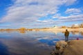 A fishing woman, church and skies