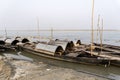 Fishing wooden boat moored in the river side. Ten small fishing boat with fishing net and equipment Royalty Free Stock Photo