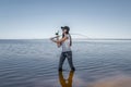 Fishing. Young fisherwoman with tackles at lake coast Royalty Free Stock Photo