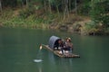 Fishman catching fish in canoe