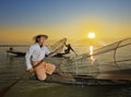 Fishman and net in Canoe sunrise Royalty Free Stock Photo