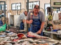 Fishmonger in Fuseta Market Hall, Eastern Algarve, Portugal.