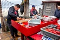 Fishmonger preps fish - wideshot