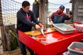 Fishmonger preps fish - wideshot