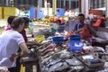 Fishmonger selling fishes at morning wet market