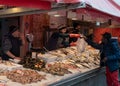 fishmonger selling fresh fish to clients at the market in downtown Syracuse